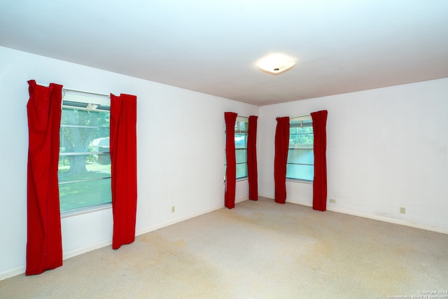 unfurnished room featuring light colored carpet