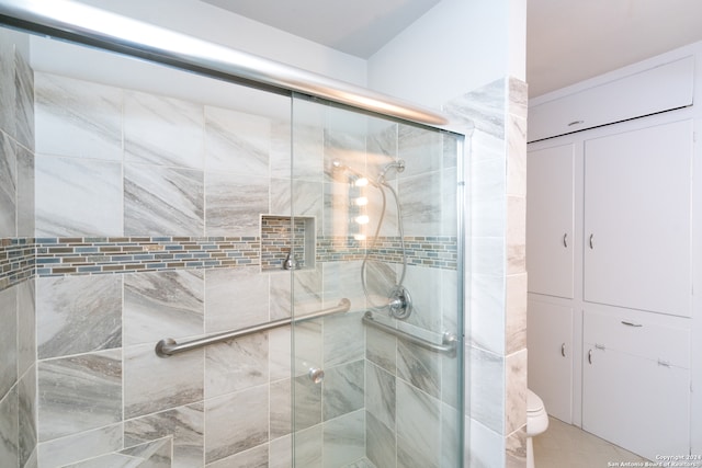 bathroom featuring toilet and an enclosed shower