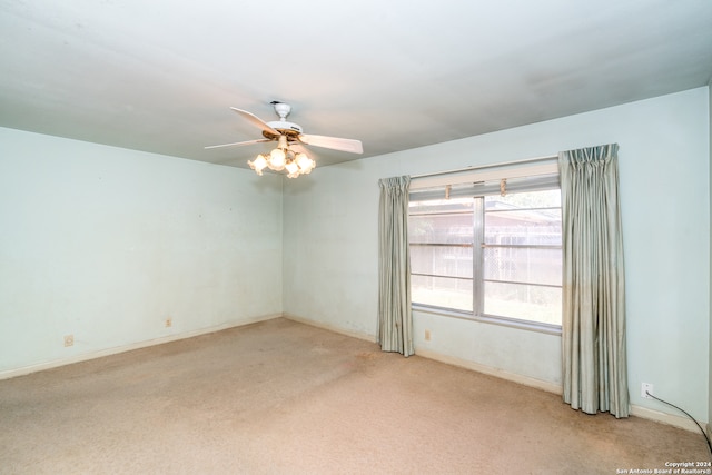 carpeted empty room featuring ceiling fan