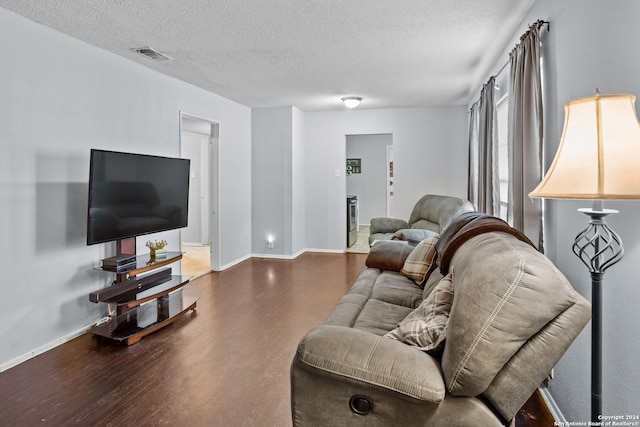 living room featuring a textured ceiling and hardwood / wood-style floors