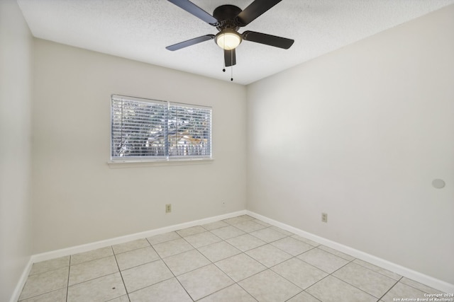 tiled spare room with ceiling fan and a textured ceiling