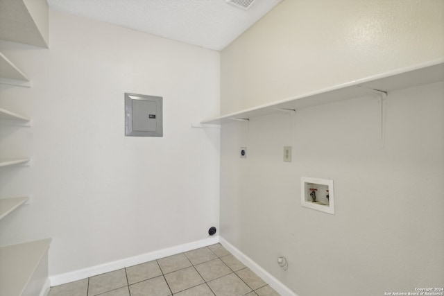 clothes washing area with washer hookup, electric dryer hookup, electric panel, and light tile patterned floors