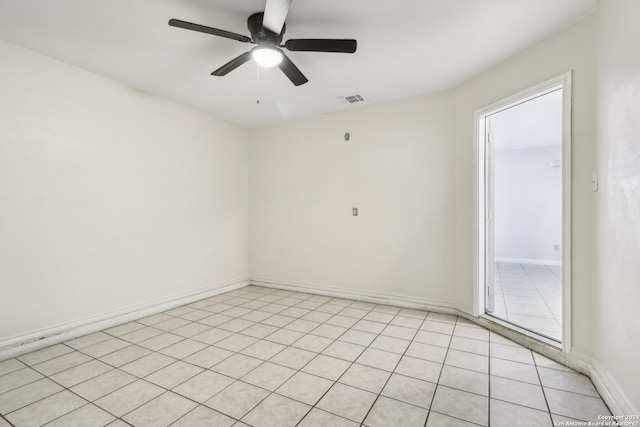 empty room with ceiling fan and light tile patterned floors