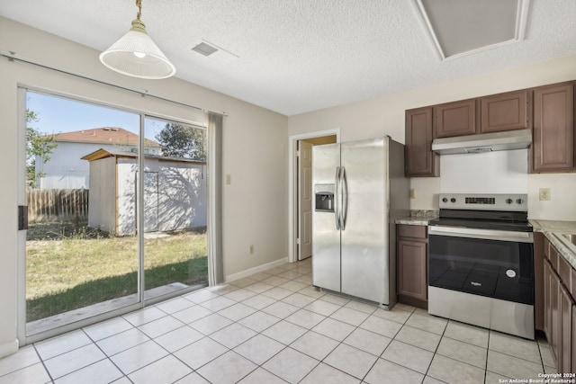 kitchen featuring dark brown cabinetry, light tile patterned floors, stainless steel appliances, and decorative light fixtures