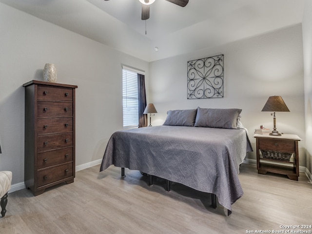 bedroom with light hardwood / wood-style floors and ceiling fan