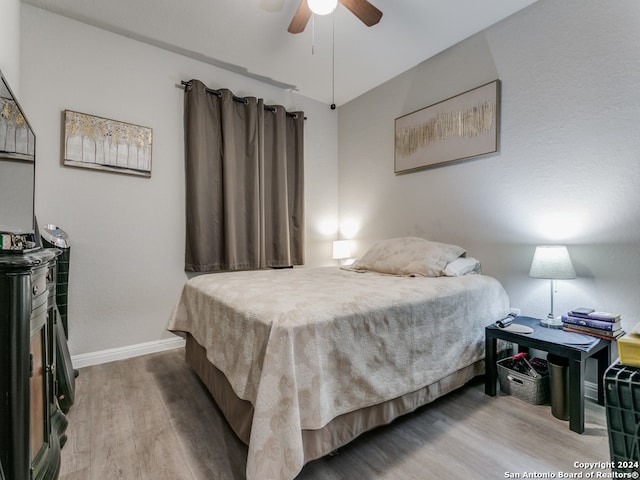 bedroom with ceiling fan and hardwood / wood-style flooring