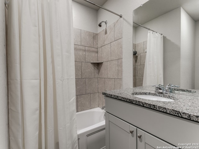 bathroom featuring shower / bath combo and vanity