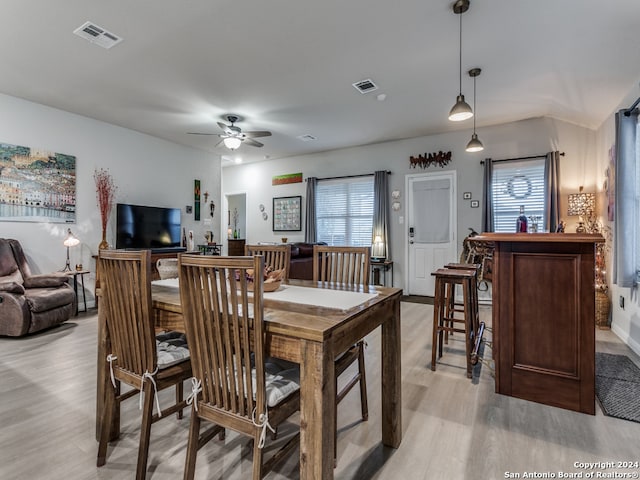 dining area with light wood-type flooring and ceiling fan