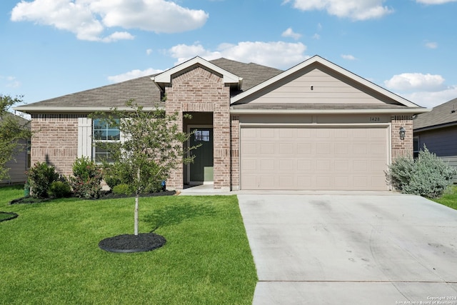 view of front facade with a front yard and a garage