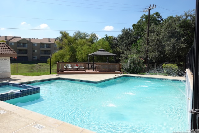 view of pool featuring pool water feature and a community hot tub