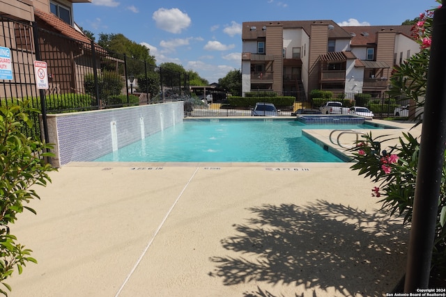 view of swimming pool featuring pool water feature