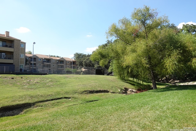 view of property's community with a lawn