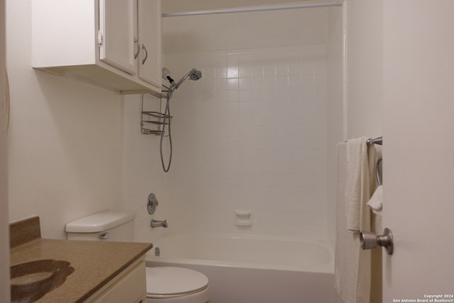 full bathroom featuring tiled shower / bath, vanity, and toilet