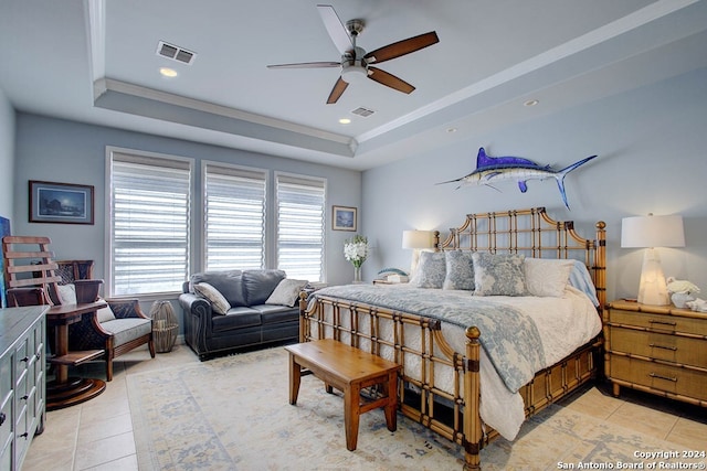 bedroom with ceiling fan, a raised ceiling, light tile patterned floors, and crown molding