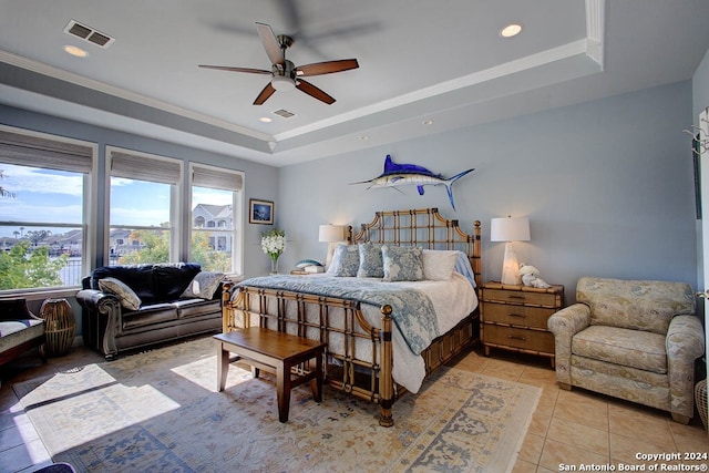 tiled bedroom with a raised ceiling, crown molding, and ceiling fan