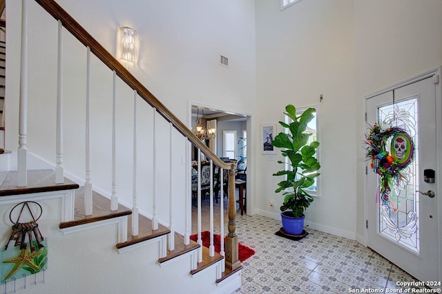 entryway featuring a chandelier and a high ceiling