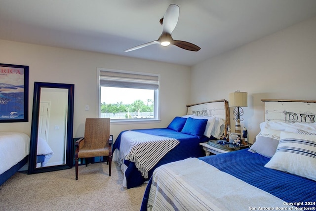 bedroom featuring light carpet and ceiling fan