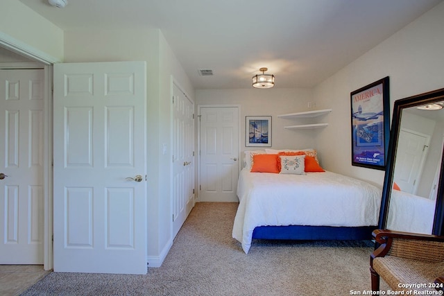 bedroom featuring light colored carpet