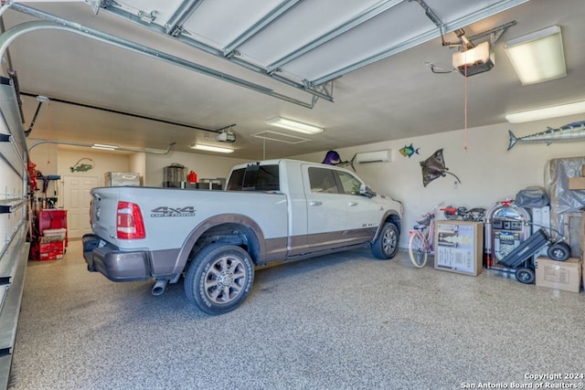 garage with a garage door opener and a wall unit AC