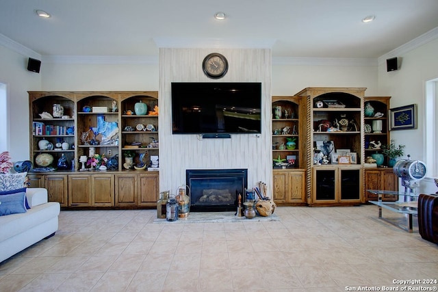 living room featuring ornamental molding and a large fireplace