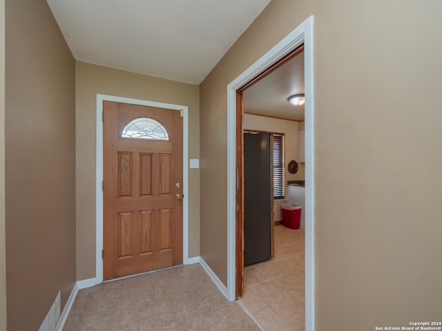 foyer entrance with light tile patterned floors