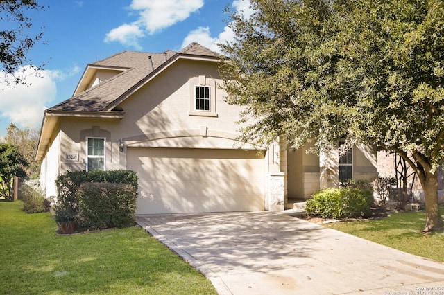 view of front facade with a front yard and a garage