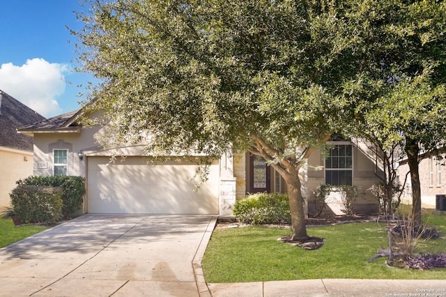 obstructed view of property with a garage and a front yard