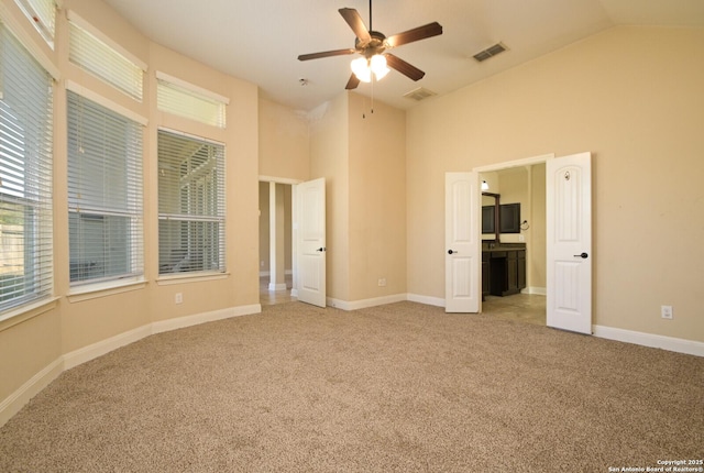 unfurnished bedroom featuring ceiling fan, high vaulted ceiling, and light colored carpet