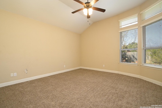 carpeted empty room featuring ceiling fan and lofted ceiling