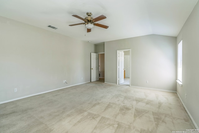 carpeted empty room featuring vaulted ceiling and ceiling fan