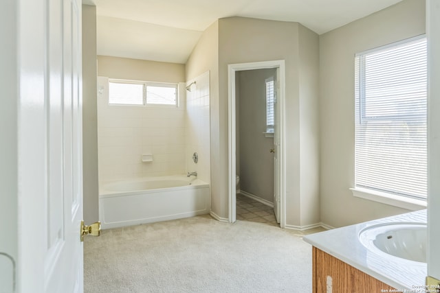 full bathroom featuring lofted ceiling, vanity, toilet, and a wealth of natural light