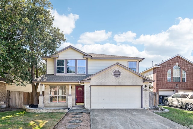 view of property with a front yard and a garage