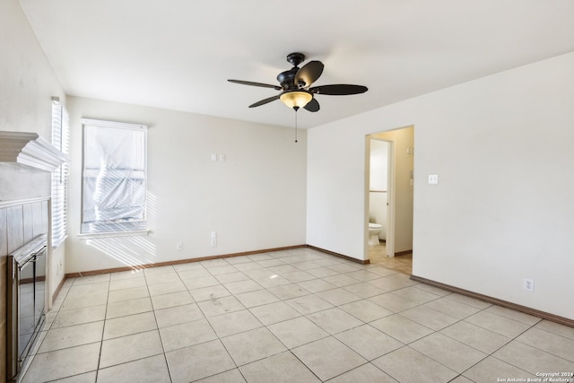 spare room featuring ceiling fan and light tile patterned floors