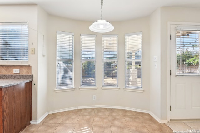 unfurnished dining area with light tile patterned floors