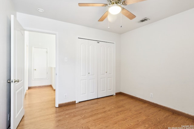 unfurnished bedroom with ceiling fan, light hardwood / wood-style flooring, and a closet