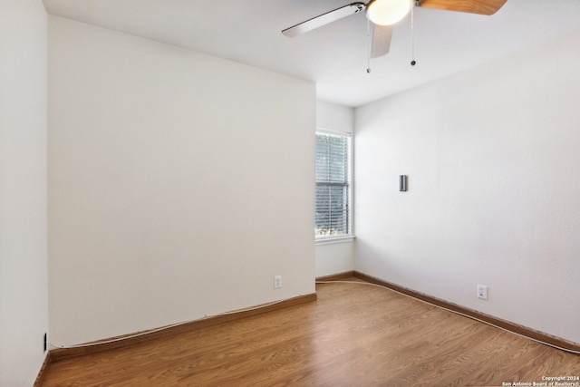 spare room featuring ceiling fan and hardwood / wood-style flooring