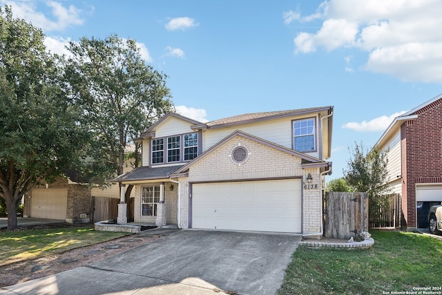 view of front property featuring a front lawn and a garage