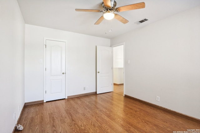 unfurnished bedroom featuring light wood-type flooring and ceiling fan