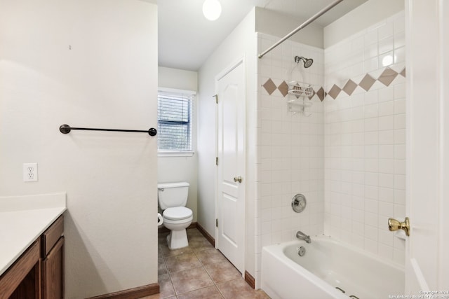 full bathroom with tiled shower / bath, vanity, tile patterned flooring, and toilet