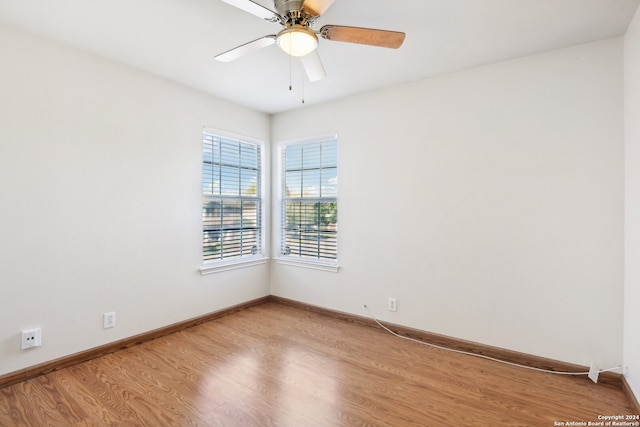 spare room with light wood-type flooring and ceiling fan