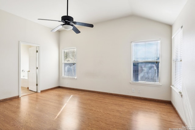 spare room featuring light hardwood / wood-style flooring, vaulted ceiling, and ceiling fan