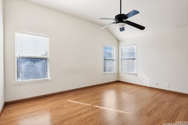 spare room featuring light hardwood / wood-style flooring, lofted ceiling, and ceiling fan