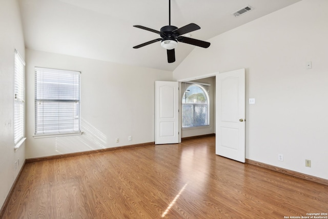 unfurnished room with lofted ceiling, ceiling fan, and hardwood / wood-style flooring