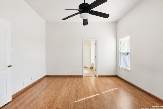 interior space with ceiling fan, light wood-type flooring, and connected bathroom