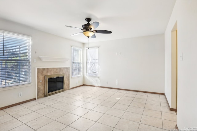 unfurnished living room featuring light tile patterned floors, ceiling fan, and a fireplace