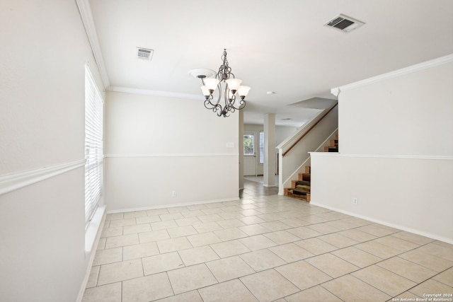 tiled spare room featuring a notable chandelier and ornamental molding