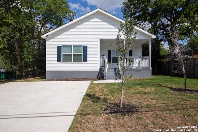 bungalow with a porch and a front lawn