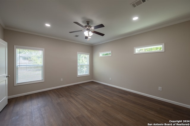 unfurnished room with ornamental molding, plenty of natural light, and dark wood-type flooring