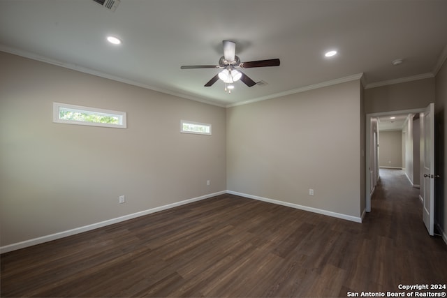 empty room featuring ornamental molding, ceiling fan, and dark wood-type flooring