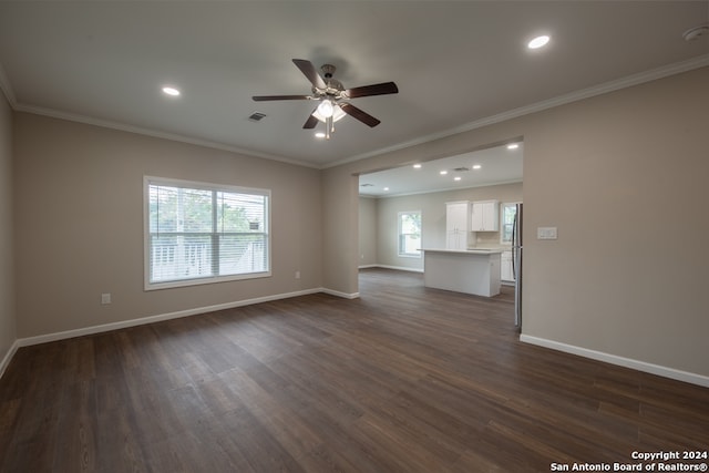 unfurnished living room featuring plenty of natural light and dark wood-type flooring